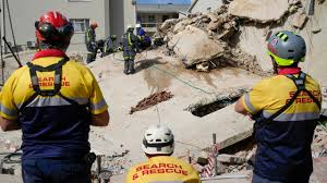 South Africa building death toll soars to 32 as crews find more bodies.